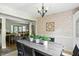 Traditional dining room features a dark wood table, an adjacent living room, and natural light at 7736 Wawasee Dr, Indianapolis, IN 46250