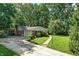 Charming single-story home with brick facade, a manicured lawn, and mature trees at 7736 Wawasee Dr, Indianapolis, IN 46250