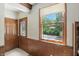 Entryway with wood paneling, a decorative front door, and a view to the front yard at 7736 Wawasee Dr, Indianapolis, IN 46250