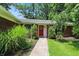 Inviting front entrance with a red door, neat landscaping, and a walkway to the house at 7736 Wawasee Dr, Indianapolis, IN 46250
