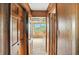 Hallway with wood paneling leading to rooms with carpet and natural light from the windows at 7736 Wawasee Dr, Indianapolis, IN 46250