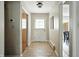 Tiled hallway featuring a closet and access to other rooms at 7736 Wawasee Dr, Indianapolis, IN 46250