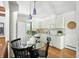 Charming eat-in kitchen featuring white cabinetry, hardwood floors, and access to the living room at 7736 Wawasee Dr, Indianapolis, IN 46250