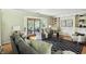 Inviting living room with hardwood floors, neutral paint, stylish furnishings, and sunroom access at 7736 Wawasee Dr, Indianapolis, IN 46250