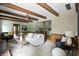 Bright living room featuring beamed ceilings, a large sofa, and an open floor plan to the kitchen at 7736 Wawasee Dr, Indianapolis, IN 46250