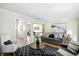 Bright and airy living room showcasing modern decor, hardwood floors, and access to other rooms at 7736 Wawasee Dr, Indianapolis, IN 46250