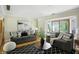 Cozy living room featuring stylish sofas, a black and white rug, and a view of the backyard at 7736 Wawasee Dr, Indianapolis, IN 46250
