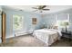 Light blue main bedroom features two windows, carpet and two side tables at 7736 Wawasee Dr, Indianapolis, IN 46250