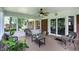 Bright and airy sunroom with wicker furniture, a ceiling fan, and access to the backyard at 7736 Wawasee Dr, Indianapolis, IN 46250