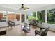Inviting sunroom with wicker furniture, a ceiling fan, and a peaceful view of the backyard at 7736 Wawasee Dr, Indianapolis, IN 46250