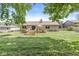 Beautiful backyard showcasing a well-maintained lawn, deck with dining area, and the home's back exterior at 792 Nevelle Ln, Carmel, IN 46032