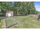 Expansive backyard featuring a storage shed, garden, mature trees, and a deck, perfect for outdoor enjoyment at 792 Nevelle Ln, Carmel, IN 46032