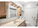 Bathroom with light wood cabinets, an oval sink in the counter, and a mirror with Hollywood lights above at 792 Nevelle Ln, Carmel, IN 46032