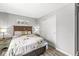 Bedroom featuring a floral bedspread, gray walls, hard wood floors and sliding-door closet at 792 Nevelle Ln, Carmel, IN 46032