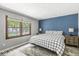 Bedroom featuring a black and white plaid bedspread, gray walls and a large window with natural light at 792 Nevelle Ln, Carmel, IN 46032