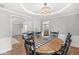 Open-concept dining room showcasing a wooden table, connecting to a living room and kitchen at 792 Nevelle Ln, Carmel, IN 46032