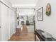 Inviting entryway with hardwood floors, neutral paint, and a view of the living room with a stone fireplace at 792 Nevelle Ln, Carmel, IN 46032