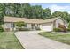 Single-story home features a curved driveway leading to the attached garage and a beautifully landscaped front yard at 792 Nevelle Ln, Carmel, IN 46032