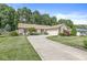 Single-story home features a long curved driveway leading to the attached garage and a beautifully landscaped front yard at 792 Nevelle Ln, Carmel, IN 46032