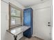 Functional laundry room with a granite folding table, blue cabinet, and a window for natural light at 792 Nevelle Ln, Carmel, IN 46032