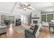 Open-concept living room with a stone fireplace, vaulted ceilings, and access to the dining area at 792 Nevelle Ln, Carmel, IN 46032