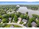 Expansive aerial view of a residential area by the lake with lush trees surrounding various beautiful houses at 817 Hickory Way, Noblesville, IN 46062