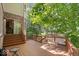 Open deck area features wooden railing and a small table, perfect for enjoying serene outdoor moments at 817 Hickory Way, Noblesville, IN 46062