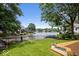 Expansive backyard with lush lawn, a sturdy fence, beautiful landscaping, and waterfront views at 817 Hickory Way, Noblesville, IN 46062