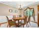 Formal dining room with elegant chandelier, hardwood table, and large windows at 817 Hickory Way, Noblesville, IN 46062