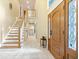 Inviting foyer with tile flooring, wooden staircase and a decorative glass door at 817 Hickory Way, Noblesville, IN 46062