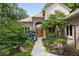 Beautifully landscaped front entrance with mature trees and flowering shrubs at 817 Hickory Way, Noblesville, IN 46062