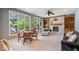 Cozy living room with a fireplace, built-in bookshelves, and a large window view at 817 Hickory Way, Noblesville, IN 46062