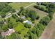 Home nestled among mature trees, complemented by a serene pond and agricultural surroundings at 881 W 1050 N, Fortville, IN 46040