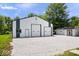 Large white and green barn with multiple garage doors and gravel area at 881 W 1050 N, Fortville, IN 46040