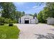 Large white and green barn with multiple garage doors and a gravel driveway at 881 W 1050 N, Fortville, IN 46040