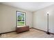 Simple bedroom featuring a storage chest, a floor lamp, and a scenic view from the window at 881 W 1050 N, Fortville, IN 46040