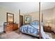 This bedroom features a four-poster bed, wood floors, and two matching dressers at 881 W 1050 N, Fortville, IN 46040