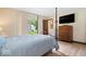 The bedroom boasts a four-poster bed, hardwood floors, and backyard access to a sliding glass door at 881 W 1050 N, Fortville, IN 46040