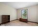 Simple bedroom featuring a wood bookcase, storage chest, and a scenic view from the window at 881 W 1050 N, Fortville, IN 46040
