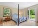 This bedroom features a four-poster bed, wood floors, and a sliding door leading to the backyard at 881 W 1050 N, Fortville, IN 46040