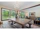 Bright dining area featuring a rustic table, chandelier, and natural light from the windows at 881 W 1050 N, Fortville, IN 46040