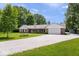 Brick home with white siding and a gravel driveway, surrounded by lush greenery at 881 W 1050 N, Fortville, IN 46040