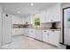 Bright kitchen with white cabinets, appliances, and a door to the outside at 881 W 1050 N, Fortville, IN 46040