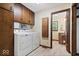 Bright laundry room with washer, dryer, and wood cabinets. Includes an adjacent bathroom at 881 W 1050 N, Fortville, IN 46040