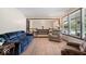 Inviting living area featuring a cozy sofa, recliner, and large windows overlooking the yard at 881 W 1050 N, Fortville, IN 46040