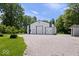 Spacious outbuilding features multiple garage doors, offering ample storage and workspace at 881 W 1050 N, Fortville, IN 46040