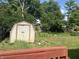 View of shed and backyard with mature trees at 8849 Summer Walk E Dr, Indianapolis, IN 46227
