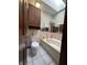 Bathroom features a bathtub and shower combination, a toilet, and an overhead skylight at 8849 Summer Walk E Dr, Indianapolis, IN 46227