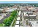Aerial view of an urban mixed-use development with residential, commercial, and green spaces at 906 Berkhamsted Ln, Carmel, IN 46032