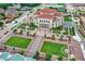 Aerial view of a performance hall with green spaces, trees, and multiple car parking spots at 906 Berkhamsted Ln, Carmel, IN 46032